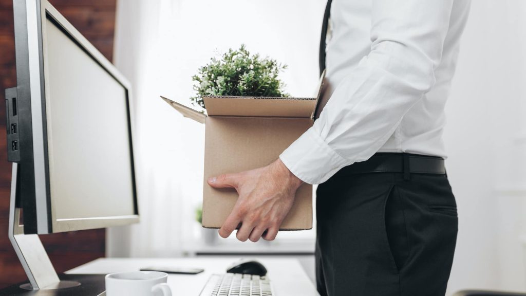 Businessman clearing his desk after being made redundant