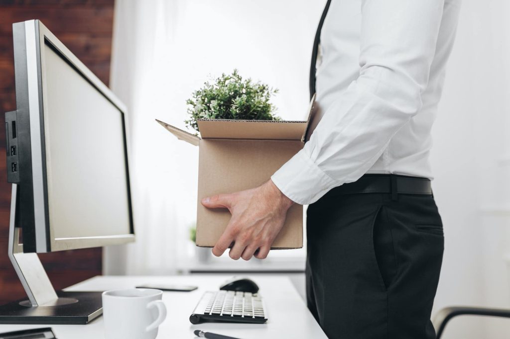 Businessman clearing his desk after being made redundant