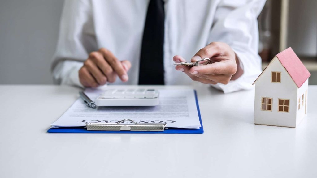 Real estate agent Sales manager holding filing keys to customer after signing rental lease contract