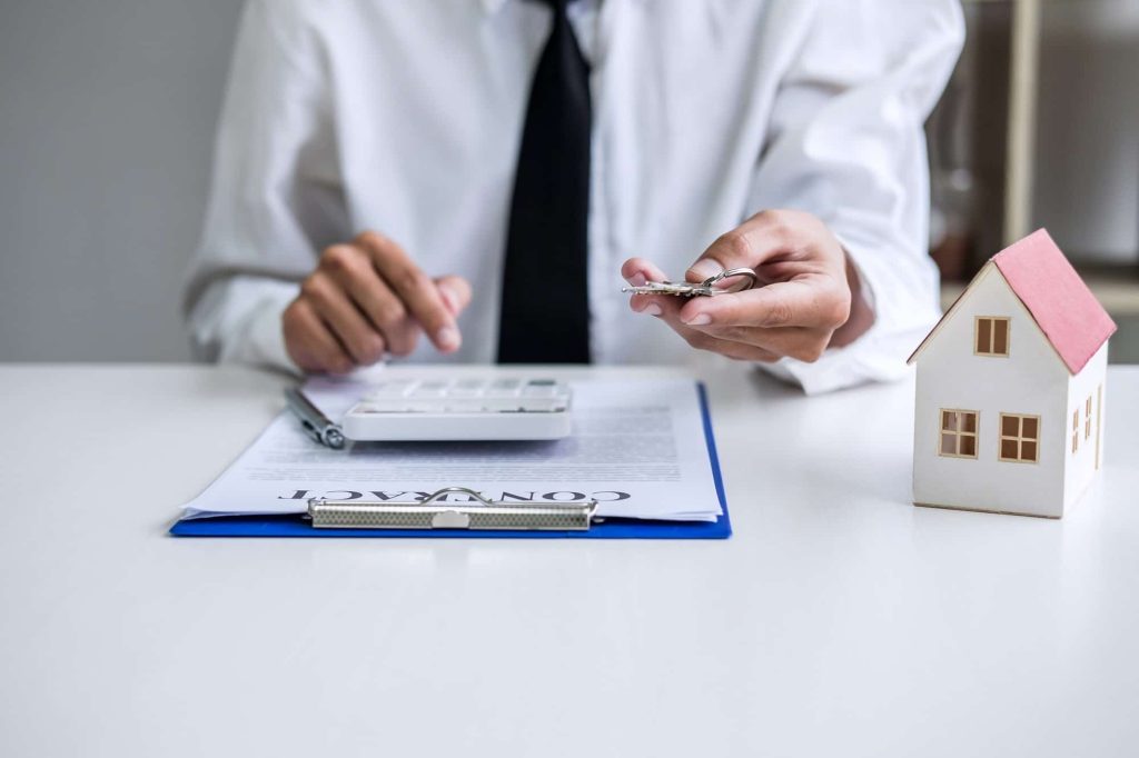 Real estate agent Sales manager holding filing keys to customer after signing rental lease contract