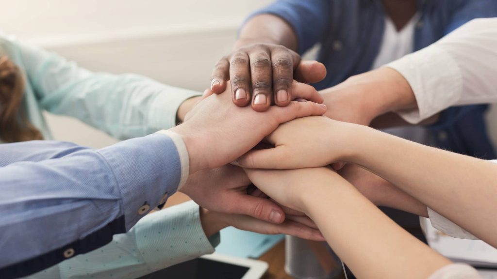 Teamwork and teambuilding, people connect hands